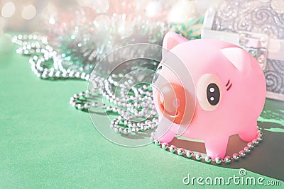 Cute toy Pink Piggy with festive tinsel garland Stock Photo