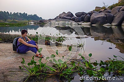 A cute turiska girl is resting on the banks of the Tungabhadra River. Hampi, Karnataka Stock Photo