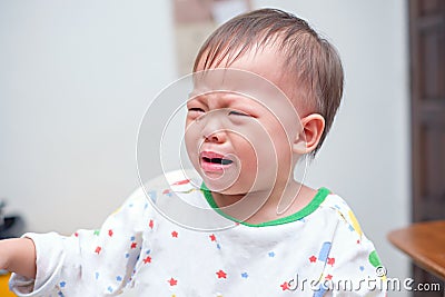 Cute upset stress sad unhappy little Asian toddler baby boy child crying, Toddler having tantrum at home Stock Photo