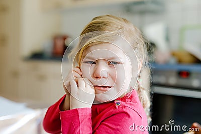 Cute upset unhappy toddler girl crying. Angry emotional child shouting. Portrait of kid with tears. Stock Photo