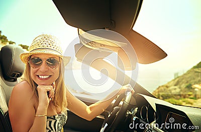 Cute woman driving convertible car Stock Photo