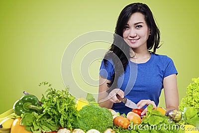 Cute woman preparing organic vegetables Stock Photo