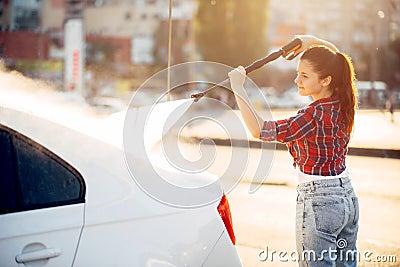 Cute woman on self service carwash Stock Photo