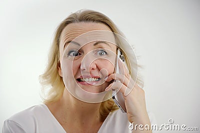 cute woman surprised by bad news talking on phone raised bad news understand that someone is taking advantage of each Stock Photo