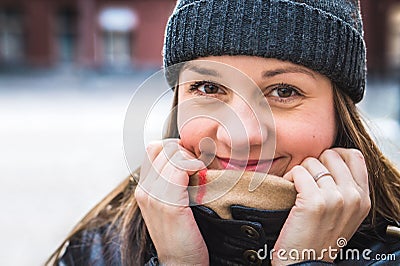 Cute woman wearing a beanie in winter. Happy and smiling person Stock Photo