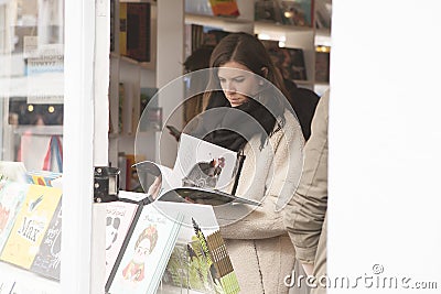 Cute women reading new book in book store Editorial Stock Photo