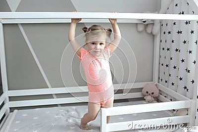 Cute 2 years little girl in her white bed at home Stock Photo