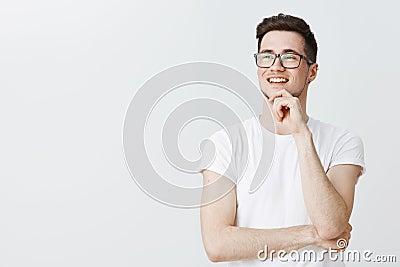 Cute young ambitious male freelancer in glasses with brislte daydreaming, looking left as enjoying view or thinking Stock Photo