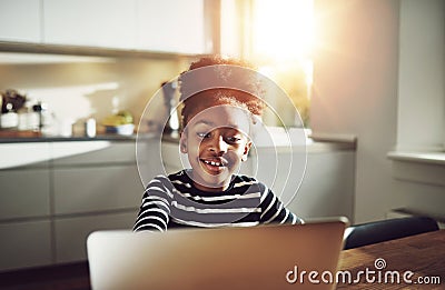 Cute young black girl playing on a laptop Stock Photo