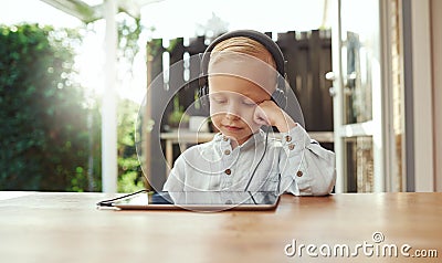 Cute young boy immersed in his music Stock Photo