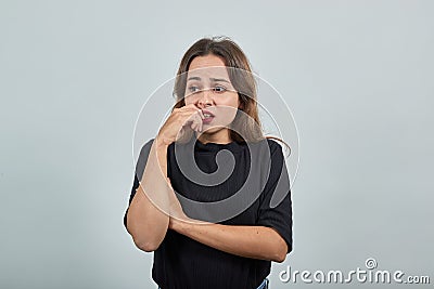Upset girl in despair opened her mouth and holds hand to face Stock Photo
