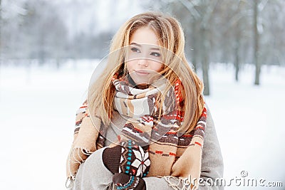 Cute young charming tender woman with vintage stylish scarf in trendy warm gray coat with knitted mittens posing Stock Photo