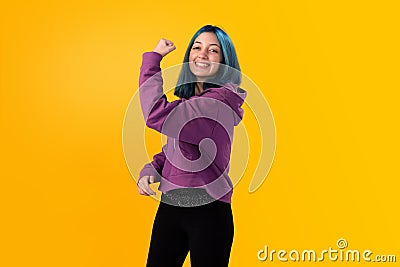 Cute young gilr with blue hair doing winner gesture Stock Photo