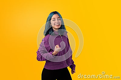 Cute young gilr with blue hair doing winner gesture Stock Photo