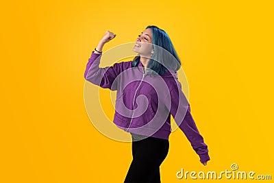 Cute young gilr with blue hair doing winner gesture Stock Photo