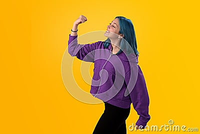 Cute young gilr with blue hair doing winner gesture Stock Photo