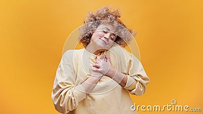 Cute Girl With Hands On Her Heart As If Expressing Gratitude And Showing Her Love Stock Photo