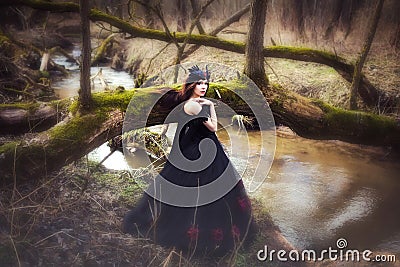 Cute young girl in dark dress fairy elf creature Stock Photo