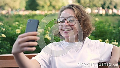 Cute Young Girl In Glasses Video Calling Or Vlogging In Summer Park