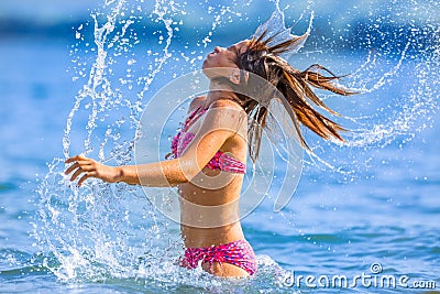 Cute young girl playing in the sea. Happy pre-teen girl enjoys summer water and holidays in holiday destinations Stock Photo