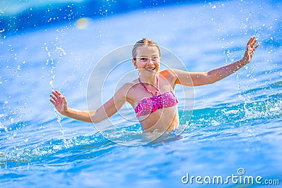 Cute young girl playing in the sea. Happy pre-teen girl enjoys summer water and holidays in holiday destinations Stock Photo