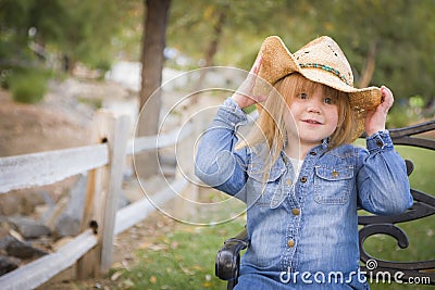 Cute Young Girl Wearing Cowboy Hat Posing for Portrait Outside Stock Photo