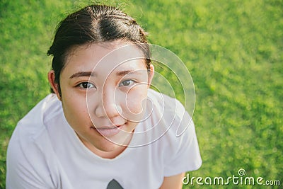 Cute young innocent asian teen smile with green grass Stock Photo
