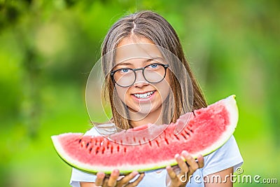 Cute young teen grirl holding in hands watermelon in garden Stock Photo