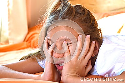 Cute young teenager girl lying on the bed. Carelessness and carelessness. Playful beautiful baby girl. Stock Photo