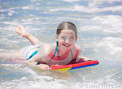 Cute young teenager smiling while on a bogie board Stock Photo