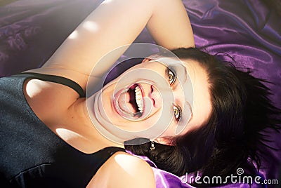 Woman fun emotion lying on bed Stock Photo