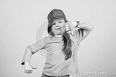 Cutie in cap. Kids fashion. Girl cute child wear cap or snapback hat beige background. Little girl wearing bright Stock Photo