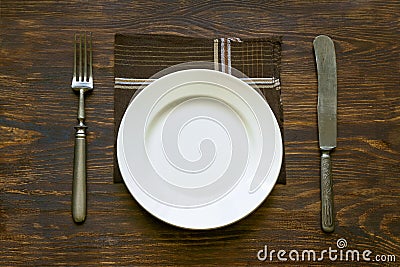 Cutlery, plate and napkin on the table Stock Photo