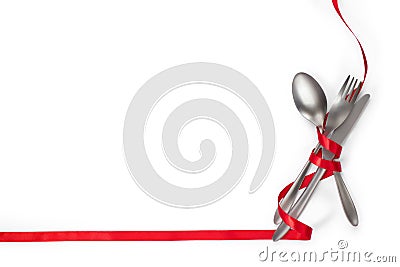 Cutlery with red ribbon as border on white background w Stock Photo