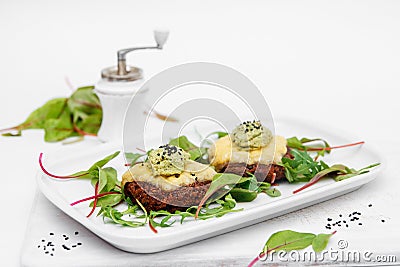 Cutlets on a white plate. Cheese, sauce, greens. White background. Decor. Stock Photo