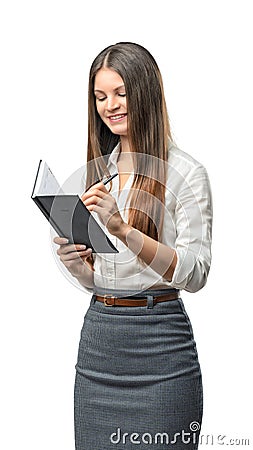 Cutout business woman writes something in notebook Stock Photo