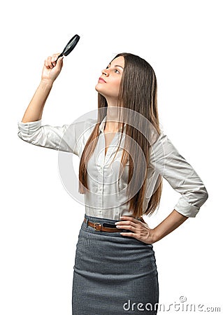 Cutout businesswoman studies something through a magnifier Stock Photo