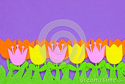 Brightly colored felt tulip flowers on a plain background Stock Photo