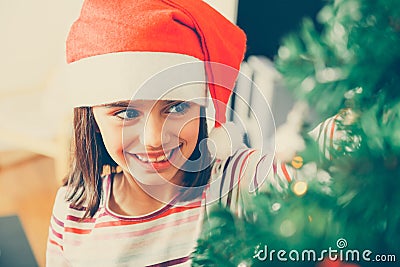 Cutte girl decorating the Christmas tree Stock Photo