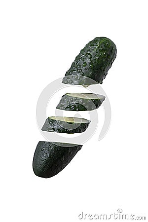 Cutted, chopped in pieces fresh wet green cucumber falling in pieces, floating in the air on white isolated background Stock Photo