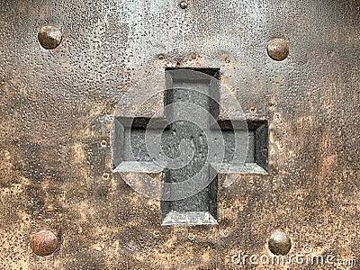 Cutted out black cross in an iron door Stock Photo