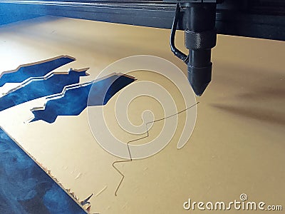 cutting acrylic plastic materials with a laser machine. Stock Photo