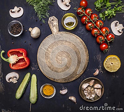 Cutting board, around lie ingredients variety of vegetables and fruits, place for text,frame wooden rustic background top view Stock Photo