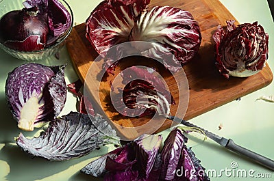 Cutting board, knife, red radicchio, red cabbage Stock Photo