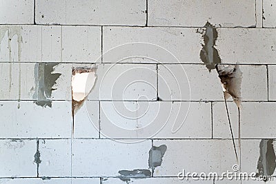 Cutting a doorway in aerated concrete wall. The process of knocking out a passage in the wall from the gas block. Redevelopment in Stock Photo