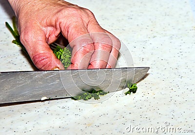 Cutting food with knife in the kitchen Stock Photo