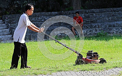 Cutting grass Editorial Stock Photo