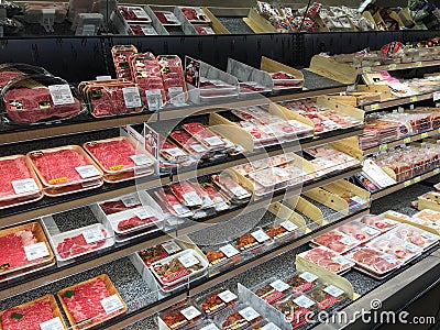 Cutting meat in refrigerator for sale at store USA Editorial Stock Photo