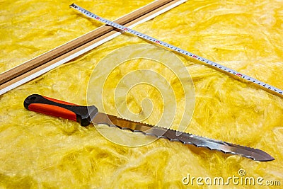 Cutting mineral wool for house insulation Stock Photo