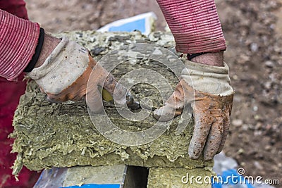 Cutting mineral wool panel with a craft knive 2 Stock Photo